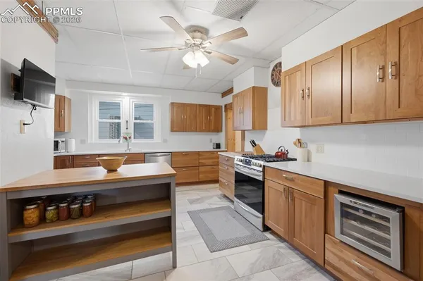 a kitchen with stainless steel appliances granite countertop a sink and cabinets