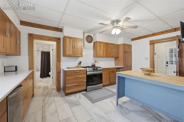 a kitchen with a stove a sink and a refrigerator
