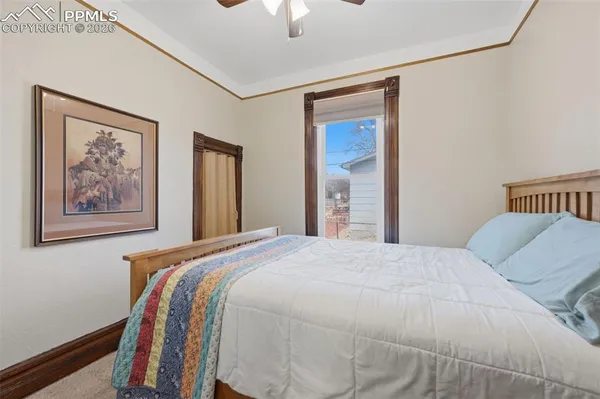 a bedroom with a bed and a painting on the wall