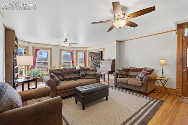 a living room with furniture and a chandelier