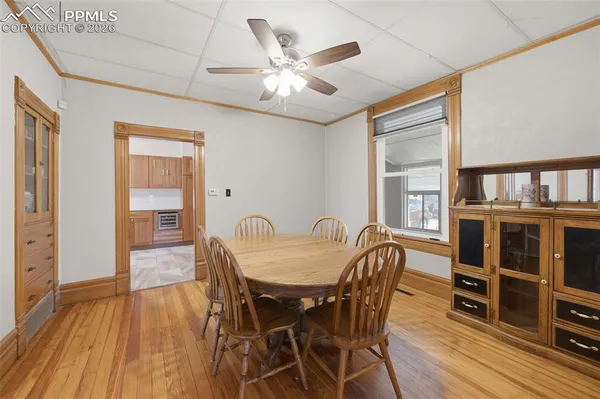 a dining room with furniture and wooden floor