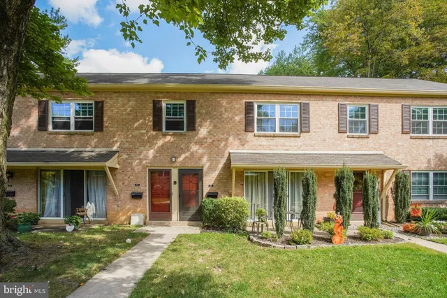front view of a brick house with a yard