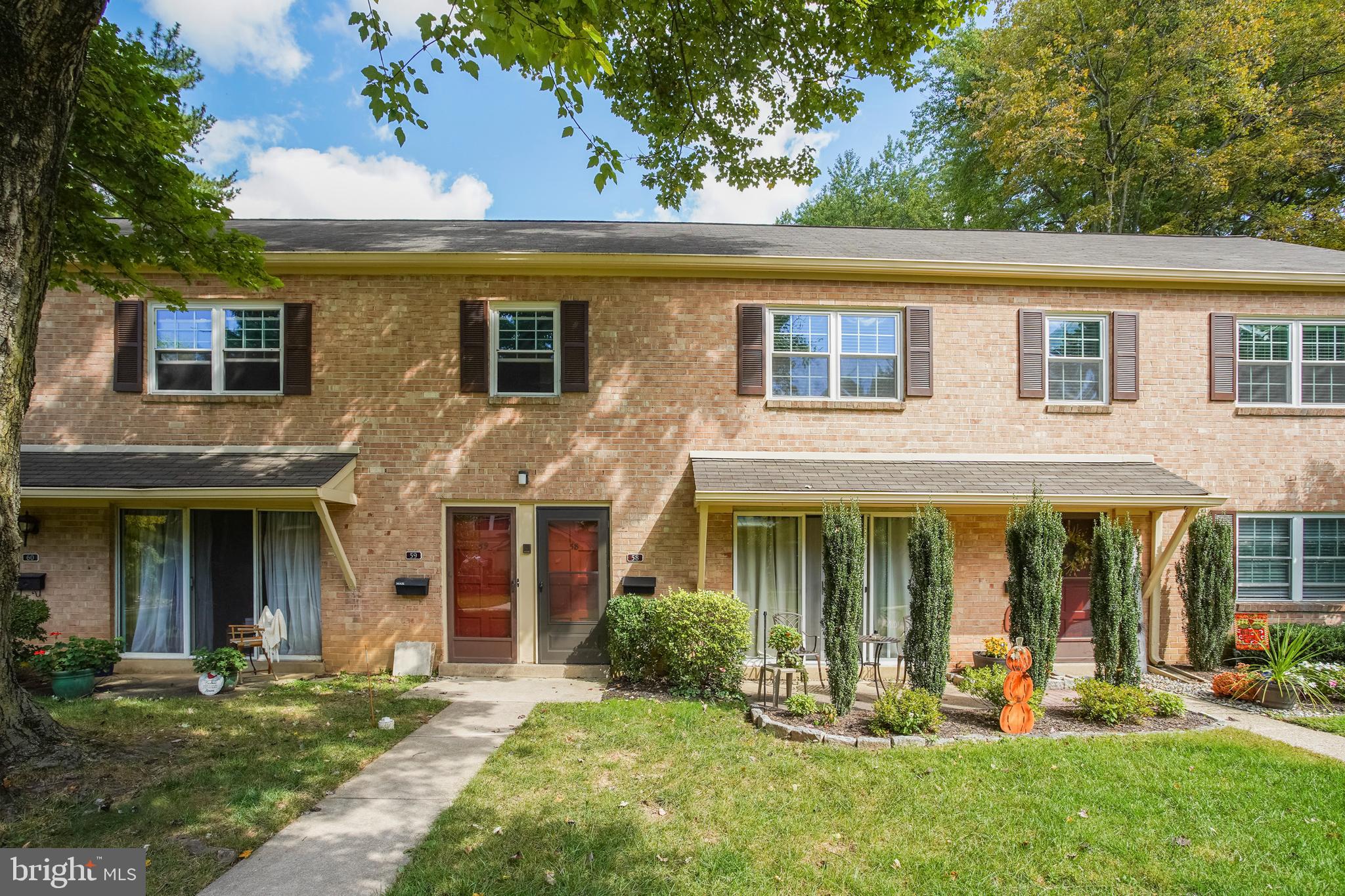 58 Old Forge Crossing Devon, PA 19333 - Photo 18 of 23 front view of a brick house with a yard