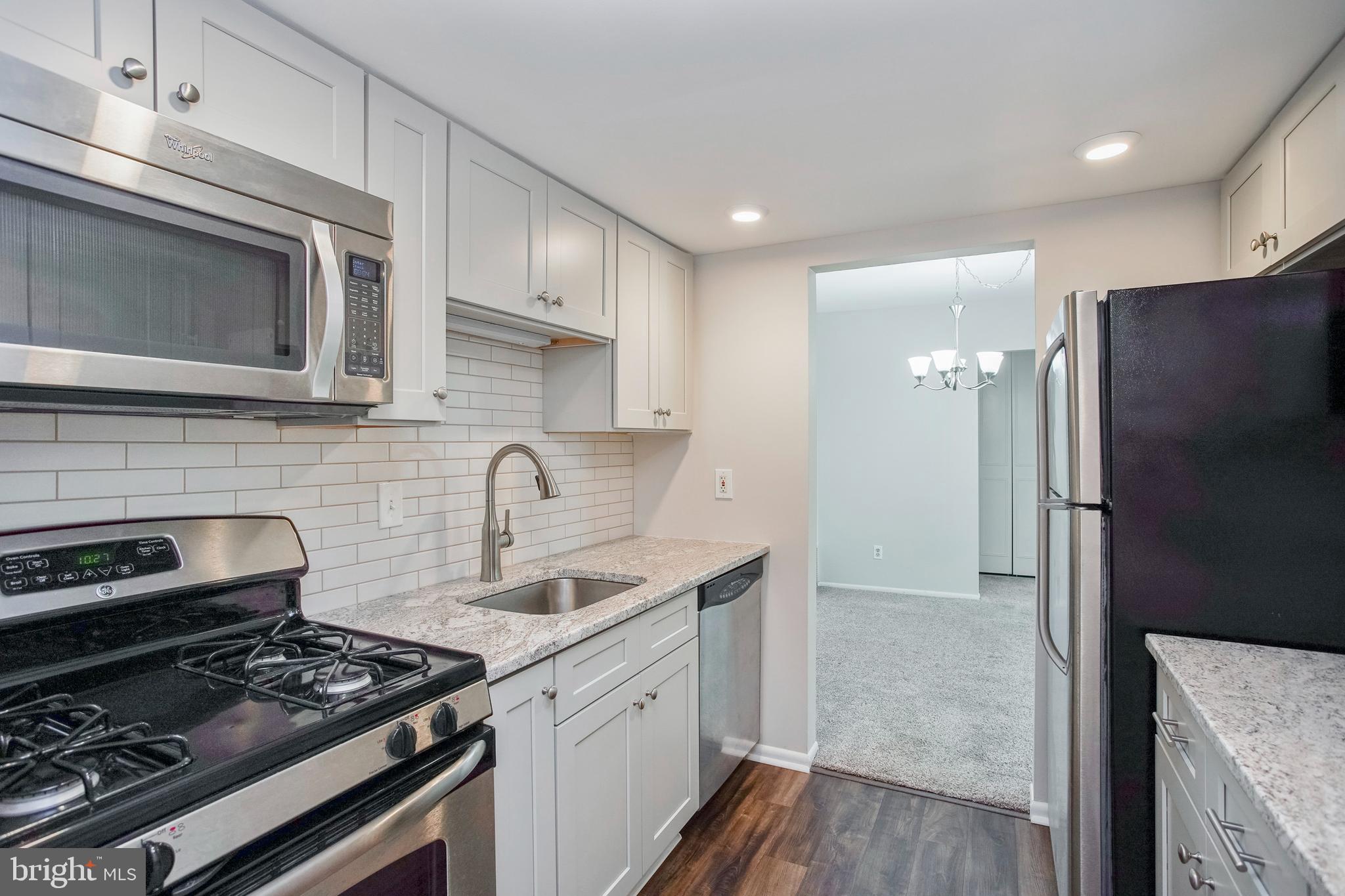 58 Old Forge Crossing Devon, PA 19333 - Photo 2 of 23 a kitchen with stainless steel appliances granite countertop a stove a refrigerator and a microwave