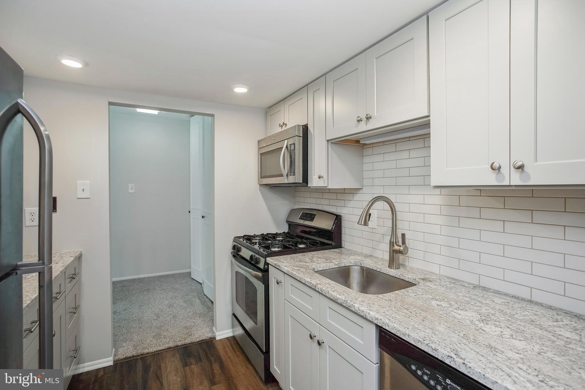 58 Old Forge Crossing Devon, PA 19333 - Photo 5 of 23 a kitchen with stainless steel appliances granite countertop a sink stove and refrigerator