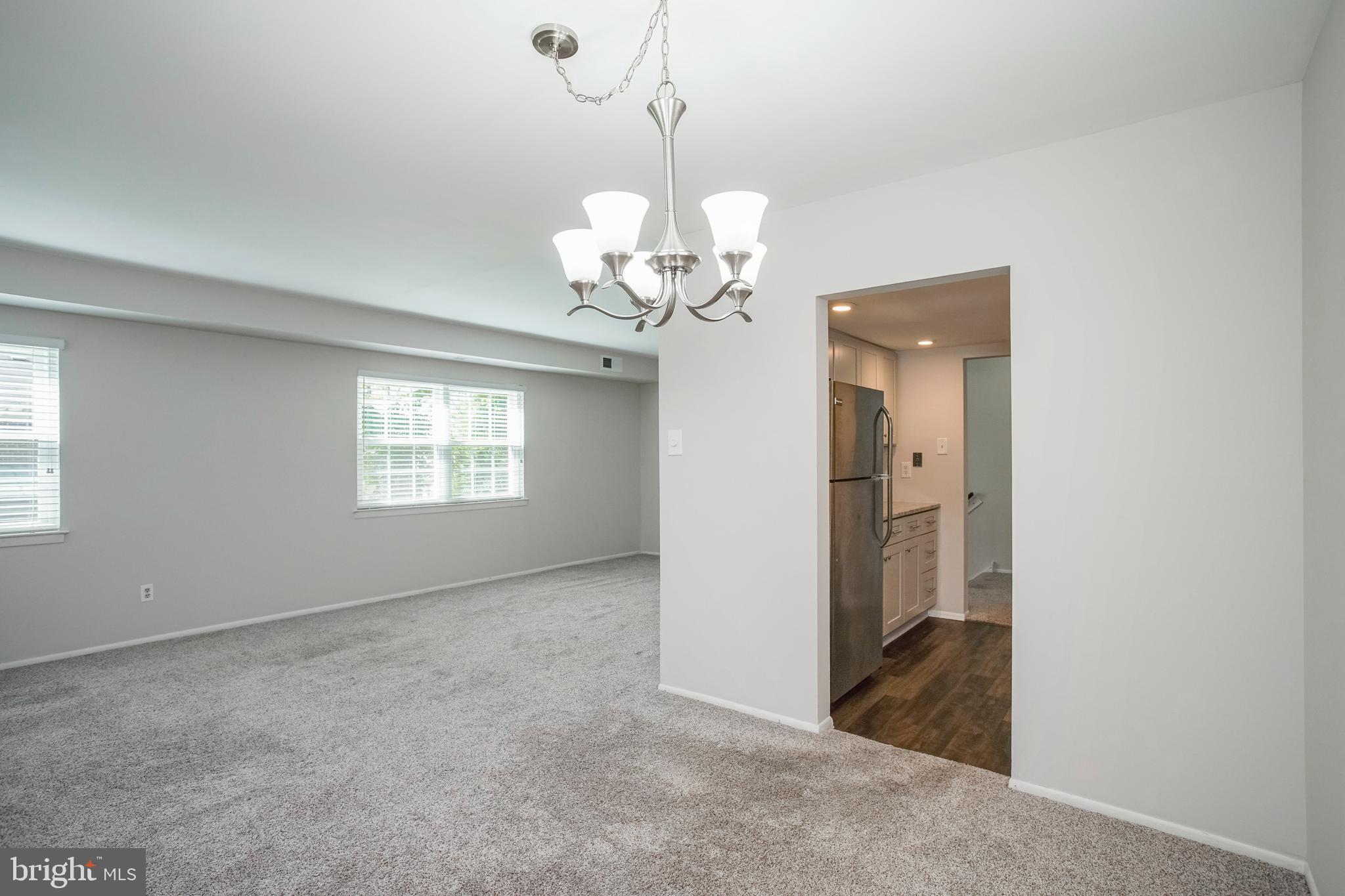 58 Old Forge Crossing Devon, PA 19333 - Photo 6 of 23 a view of a room with a chandelier fan and windows