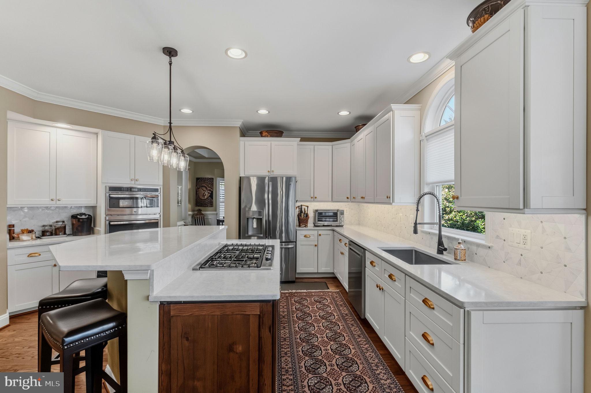 2656 Brook Valley Road Frederick, MD 21701 - Photo 23 of 89 a kitchen with stainless steel appliances kitchen island granite countertop a sink stove and refrigerator