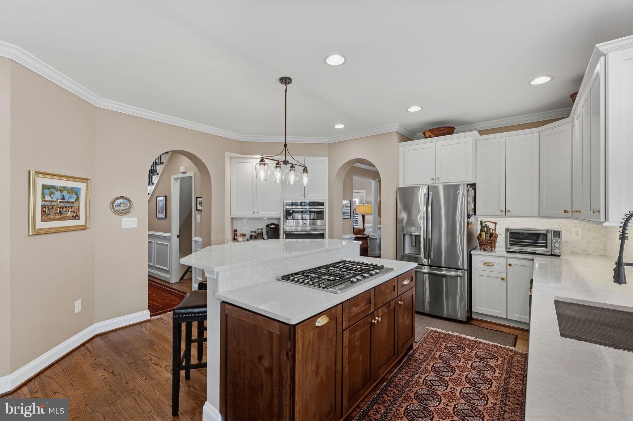 2656 Brook Valley Road Frederick, MD 21701 - Photo 24 of 89 a kitchen with stainless steel appliances kitchen island a refrigerator a stove a sink cabinets and a dining table