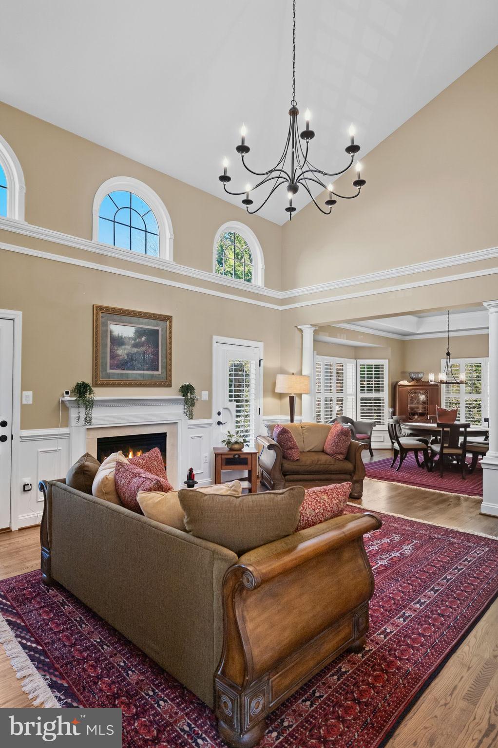 2656 Brook Valley Road Frederick, MD 21701 - Photo 7 of 89 a living room with furniture a chandelier and a fireplace