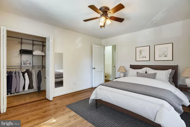 a bedroom with a bed and a painting on the wall