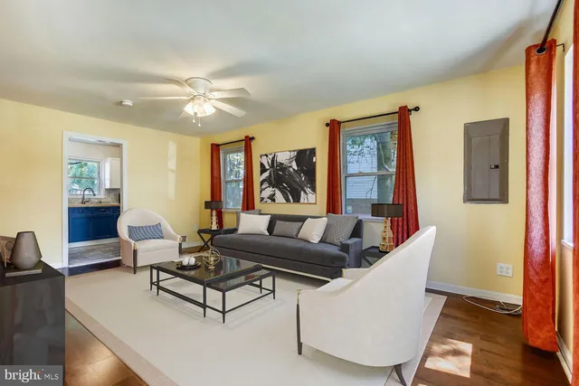 a living room with furniture and wooden floor