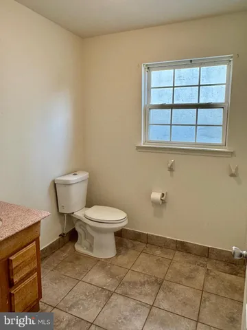 a white toilet sitting next to a bathroom sink