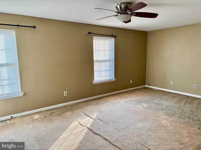 a view of a hallway with a chandelier fan and entryway