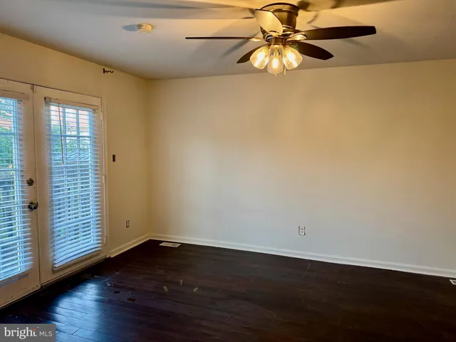 wooden floor in an empty room with a window