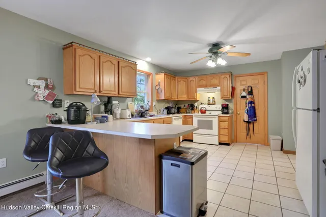 a view of a porch with furniture and a yard