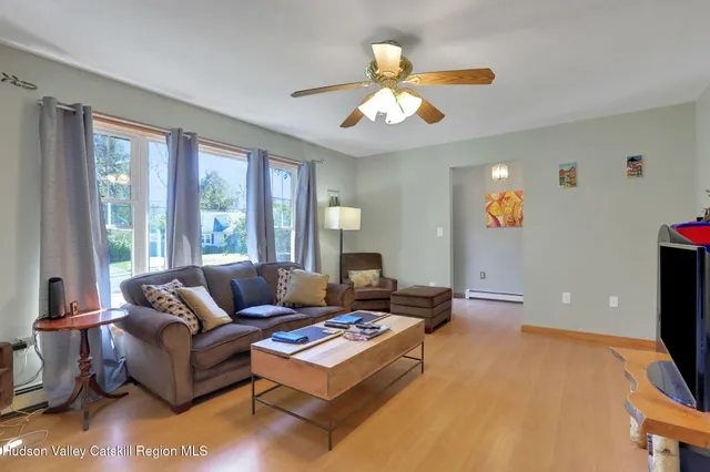 a living room with furniture a rug and a chandelier