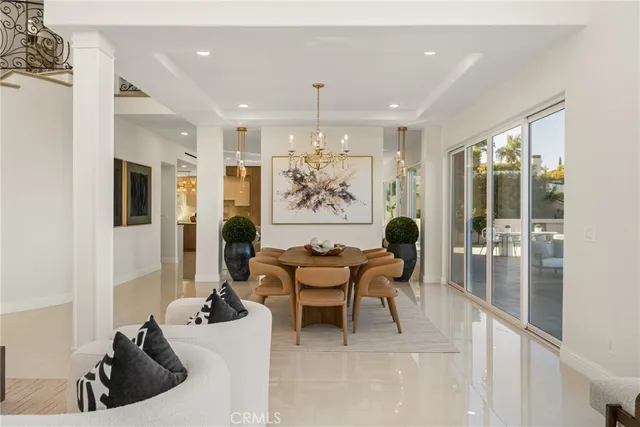 a living room with furniture and a view of kitchen