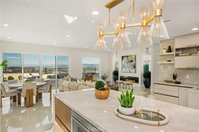 a living room with furniture and a kitchen view