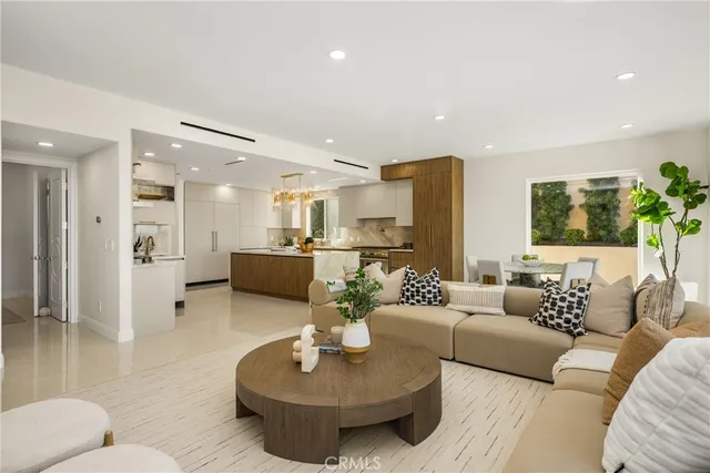 a view of a terrace with couches and lounge chairs