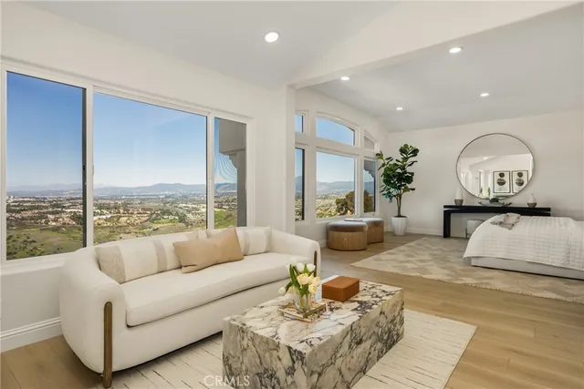 a bedroom with a bed and a painting on the wall
