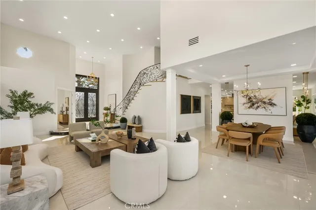 a view of a dining room with furniture a chandelier and wooden floor