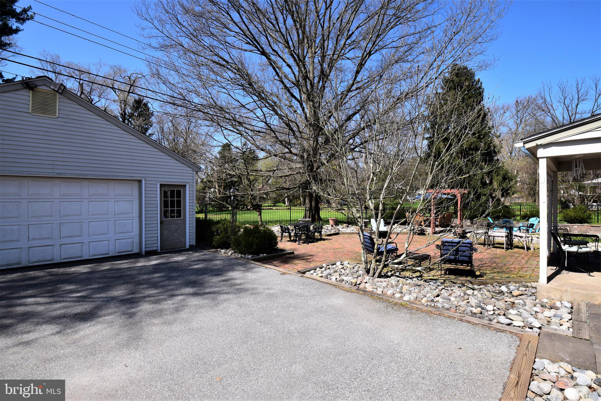 1550 Glenhardie Road Wayne, PA 19087 - Photo 2 of 38 a view of a patio with table and chairs and a barbeque