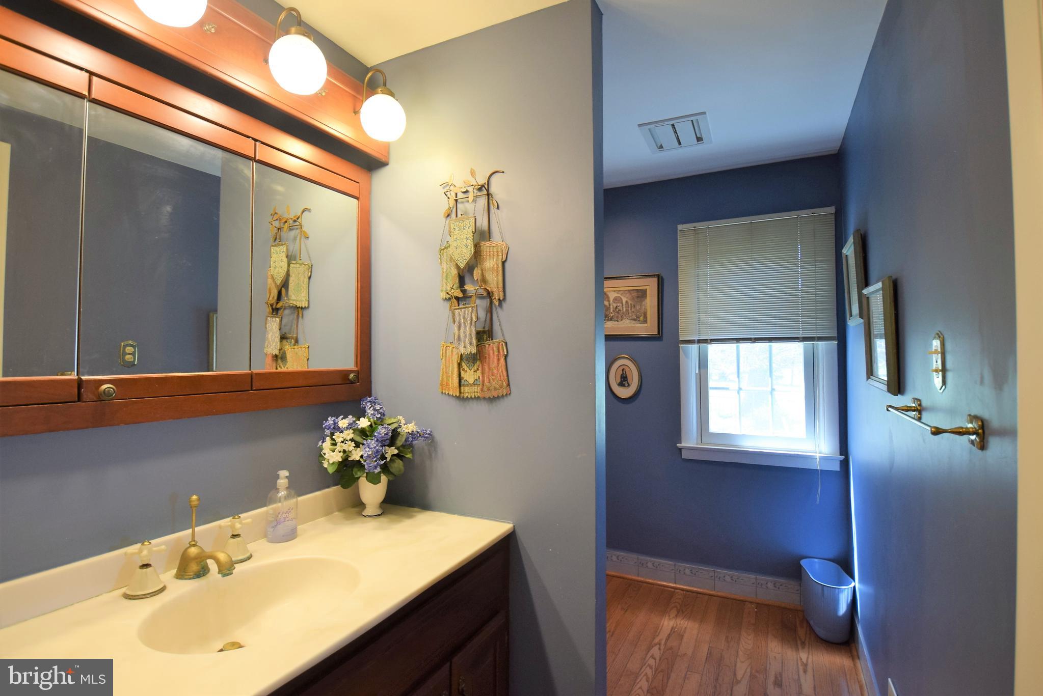 1550 Glenhardie Road Wayne, PA 19087 - Photo 16 of 38 a bathroom with a sink and a mirror
