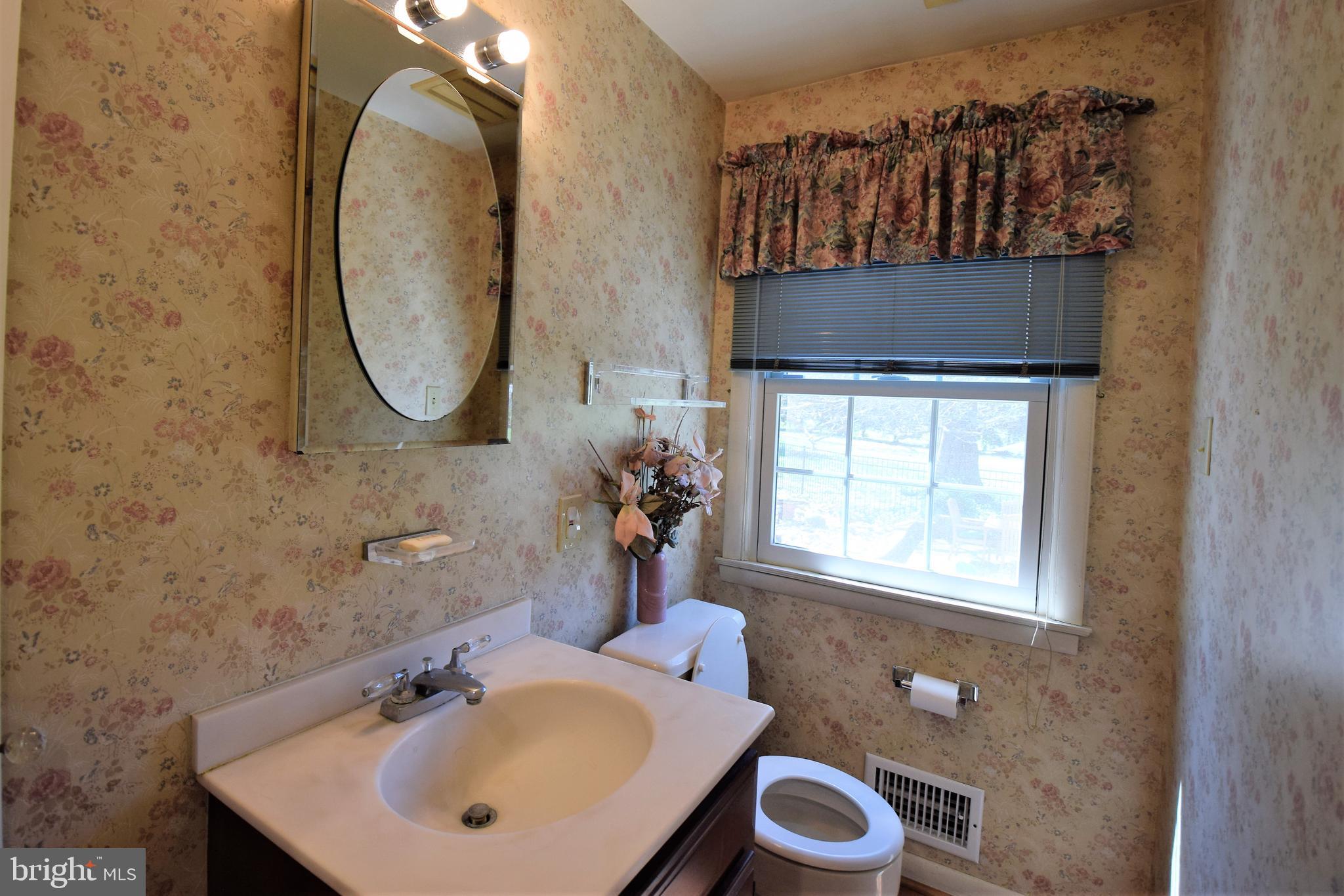 1550 Glenhardie Road Wayne, PA 19087 - Photo 17 of 38 a bathroom with a sink a mirror and a toilet