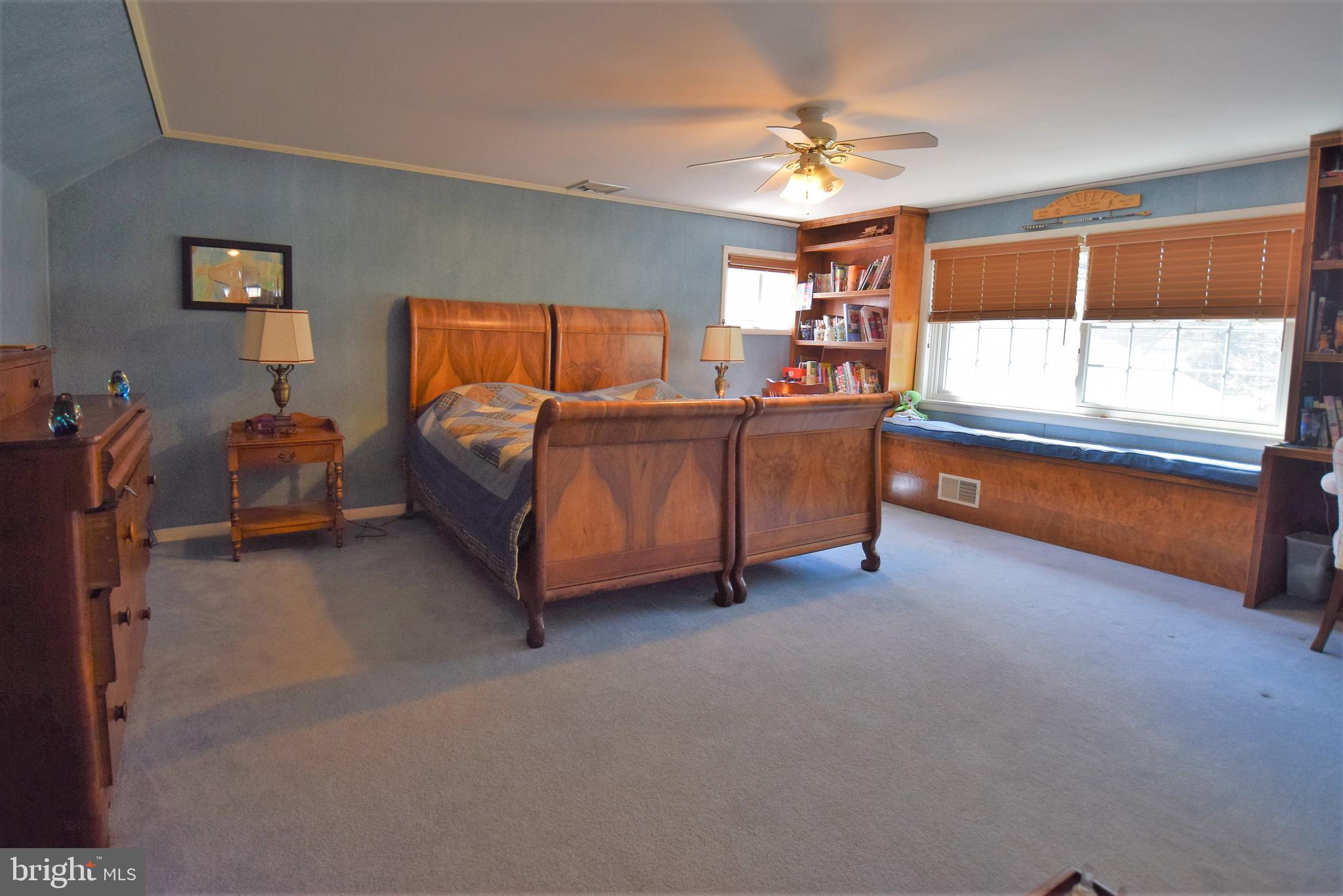 1550 Glenhardie Road Wayne, PA 19087 - Photo 19 of 38 a spacious bedroom with a bed and a chandelier