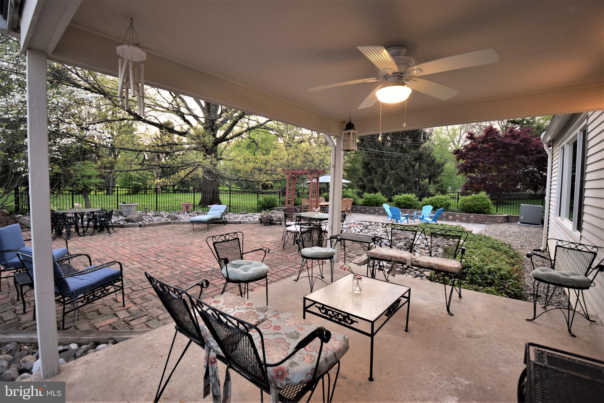 1550 Glenhardie Road Wayne, PA 19087 - Photo 3 of 38 a view of a patio with a dining table and chairs