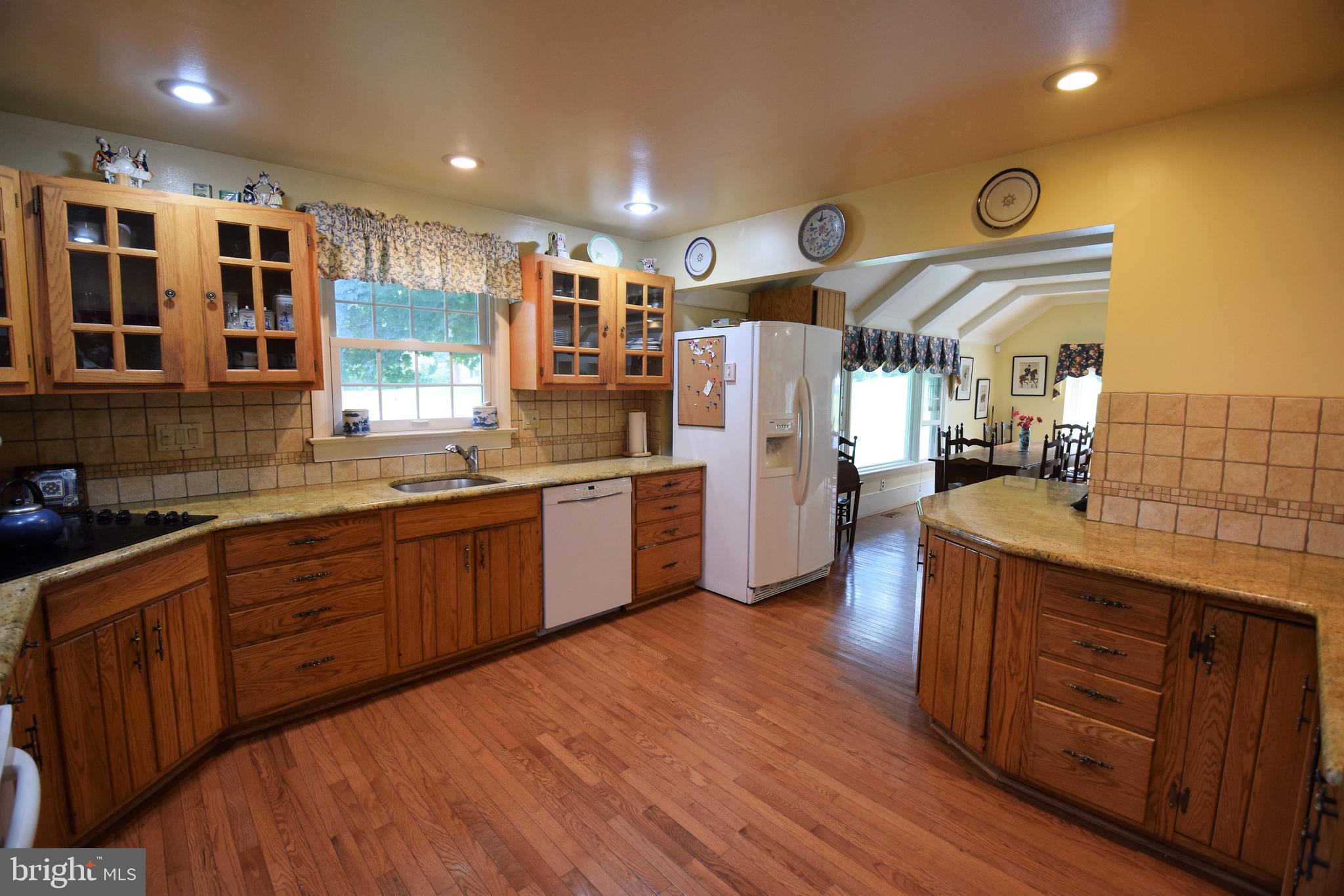 1550 Glenhardie Road Wayne, PA 19087 - Photo 31 of 38 a kitchen with stainless steel appliances granite countertop a sink and wooden cabinets