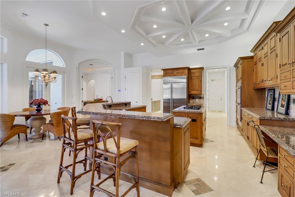 9376 Sweetgrass Way Naples, FL 34108 - Photo 15 of 49 a large kitchen with a table and chairs
