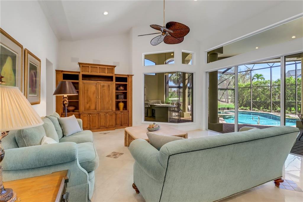 9376 Sweetgrass Way Naples, FL 34108 - Photo 16 of 49 a living room with furniture and a large window