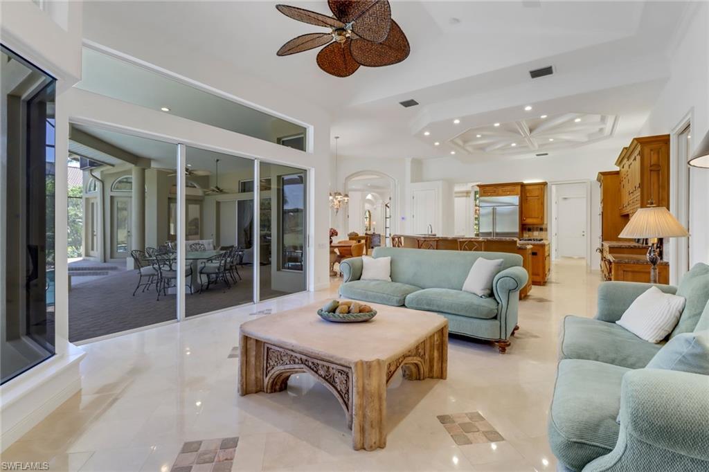 9376 Sweetgrass Way Naples, FL 34108 - Photo 18 of 49 a living room with furniture and a large window