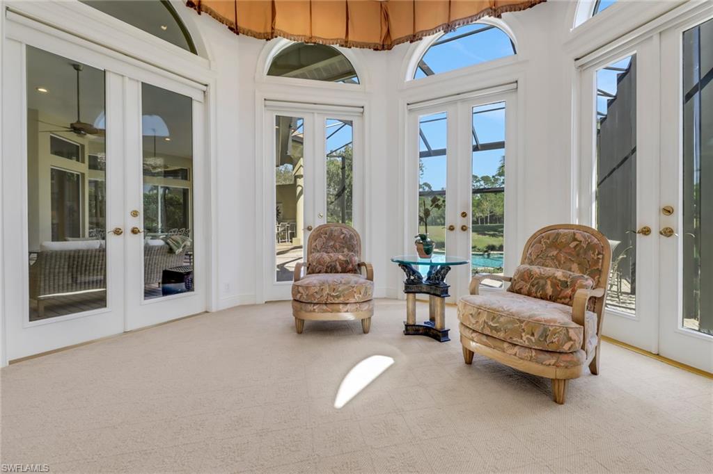 9376 Sweetgrass Way Naples, FL 34108 - Photo 21 of 49 a living room with furniture and a large window