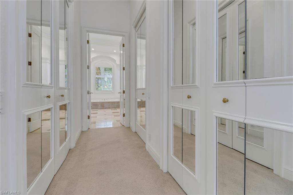 9376 Sweetgrass Way Naples, FL 34108 - Photo 22 of 49 a view of a hallway with chandelier