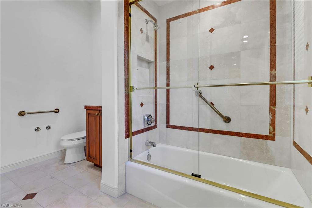 9376 Sweetgrass Way Naples, FL 34108 - Photo 34 of 49 a bathroom with a bathtub and a shower