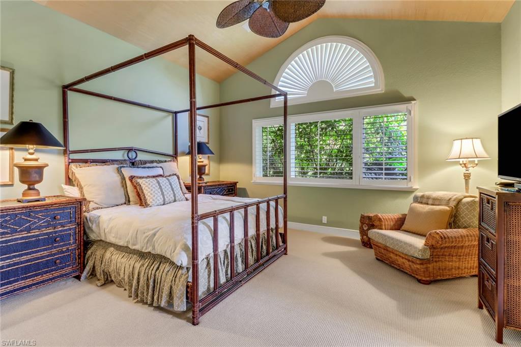 9376 Sweetgrass Way Naples, FL 34108 - Photo 37 of 49 a bed room with a bed and a chandelier