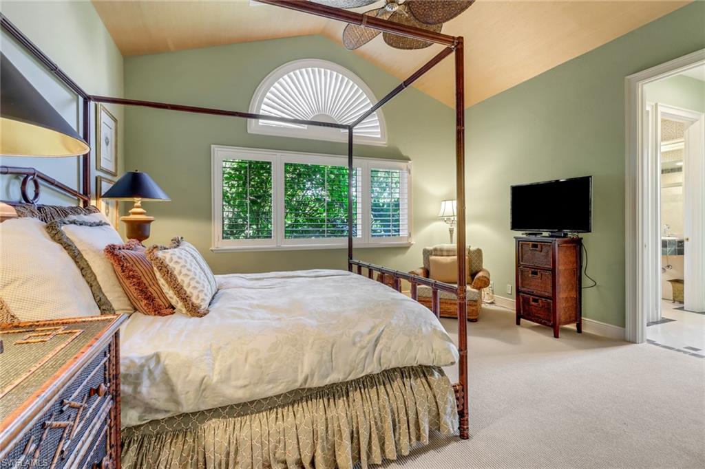 9376 Sweetgrass Way Naples, FL 34108 - Photo 38 of 49 a bedroom with a bed and a flat tv screen on dresser