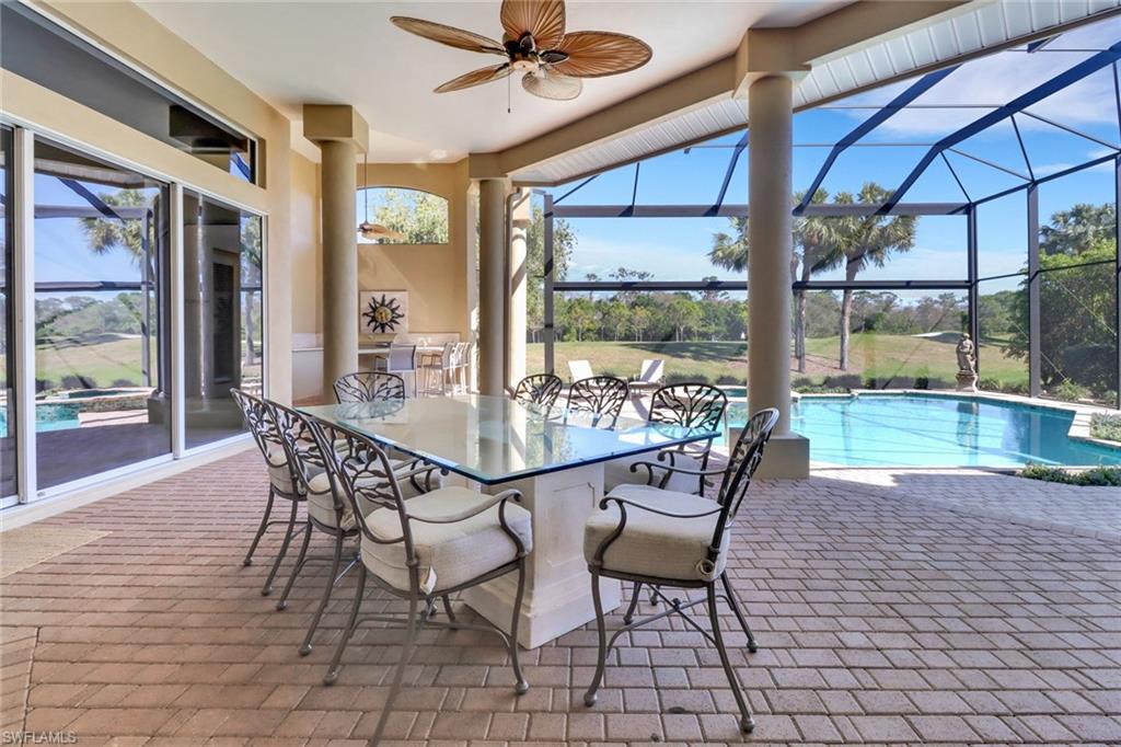9376 Sweetgrass Way Naples, FL 34108 - Photo 41 of 49 a view of a dining room with furniture wooden floor and a chandelier