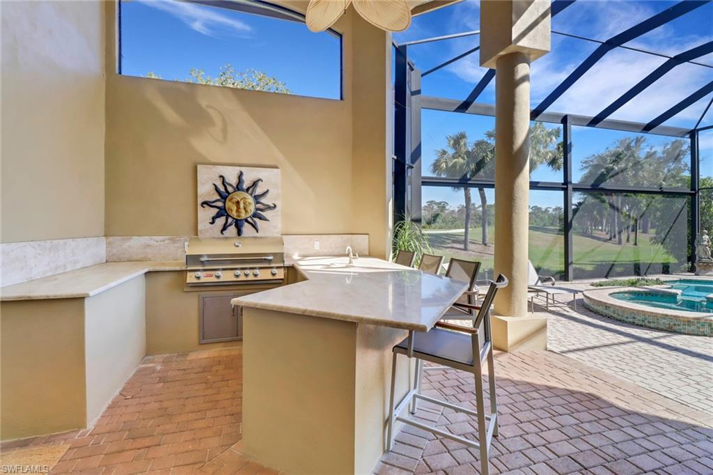 9376 Sweetgrass Way Naples, FL 34108 - Photo 43 of 49 a kitchen with a stove and a sink