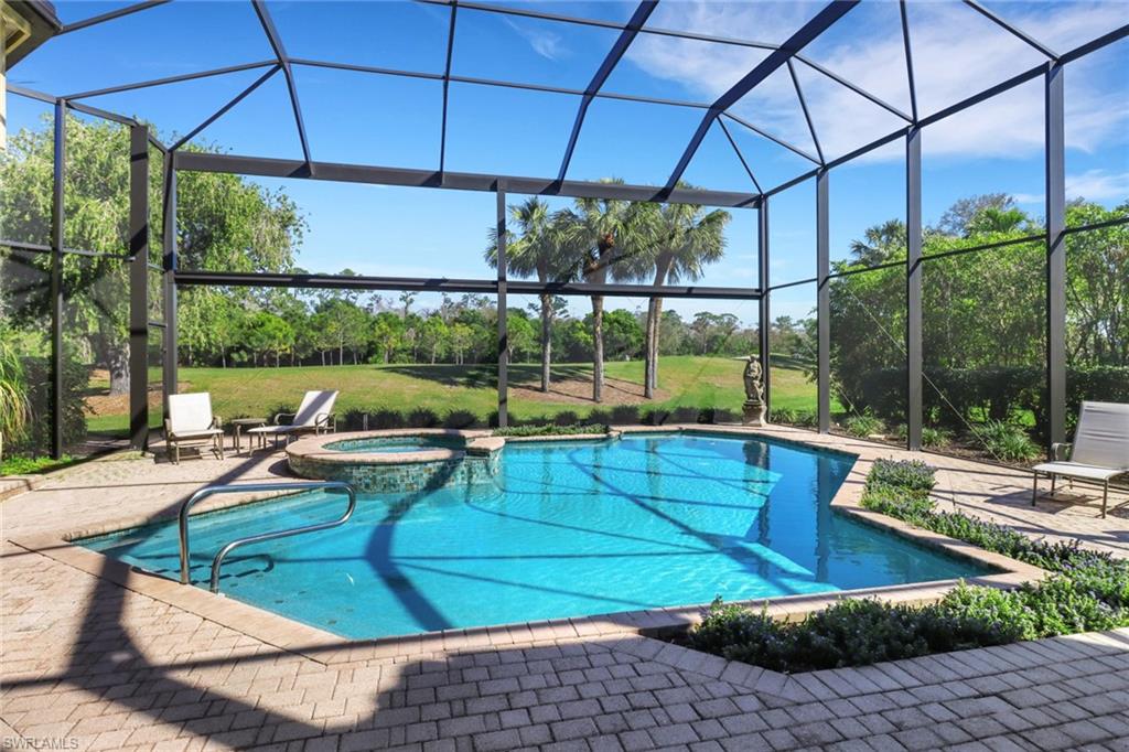 9376 Sweetgrass Way Naples, FL 34108 - Photo 45 of 49 a house view with a sitting space and garden view
