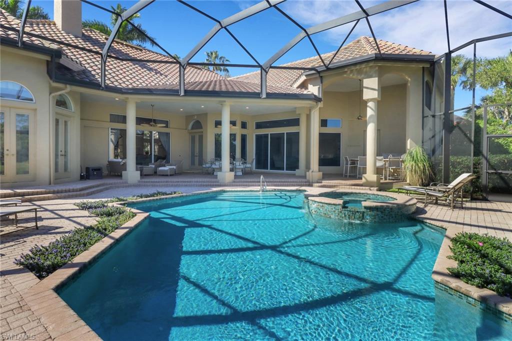 9376 Sweetgrass Way Naples, FL 34108 - Photo 47 of 49 a view of a house with backyard porch and sitting area