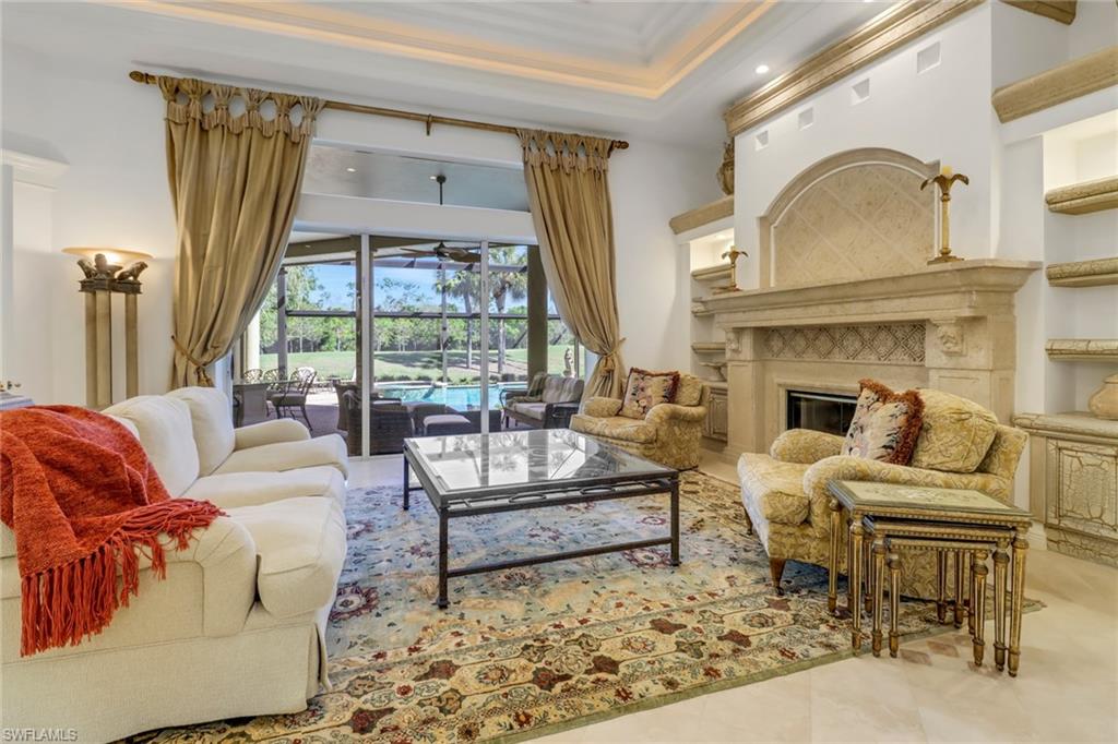 9376 Sweetgrass Way Naples, FL 34108 - Photo 5 of 49 a living room with furniture fireplace and a table