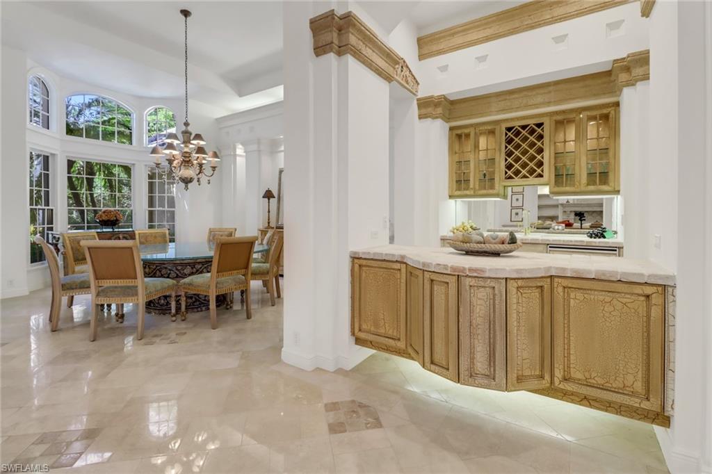 9376 Sweetgrass Way Naples, FL 34108 - Photo 9 of 49 a view of a dining room with furniture window and chandelier