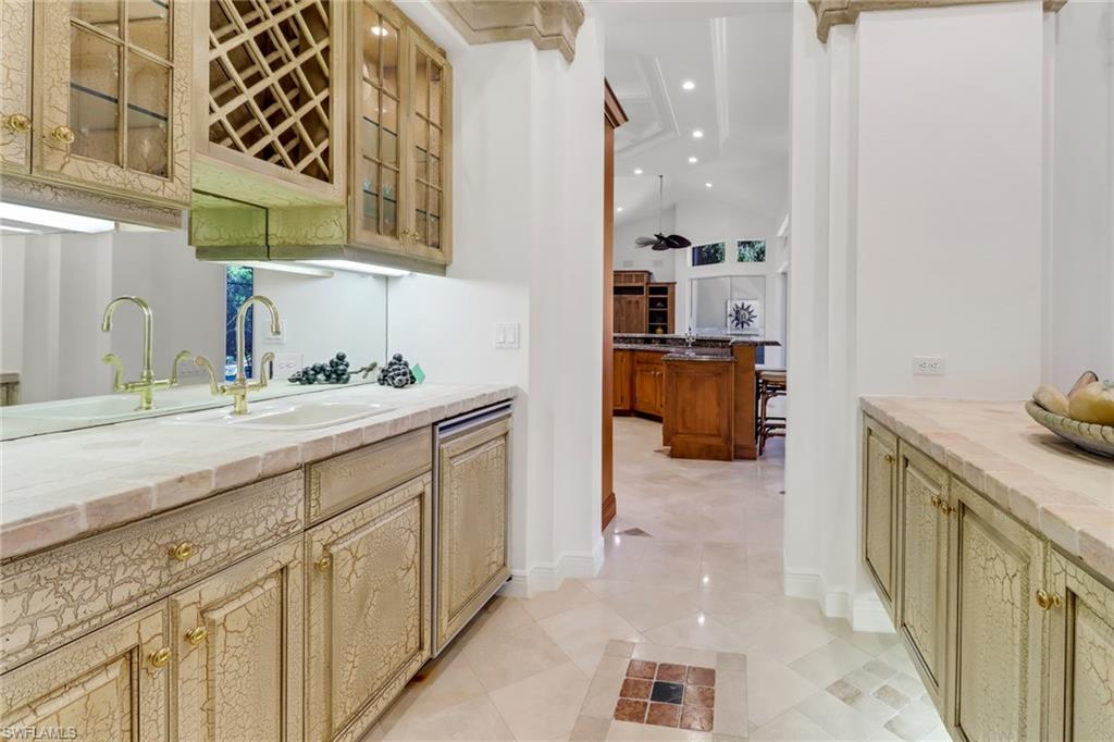 9376 Sweetgrass Way Naples, FL 34108 - Photo 10 of 49 a bathroom with a sink and a mirror