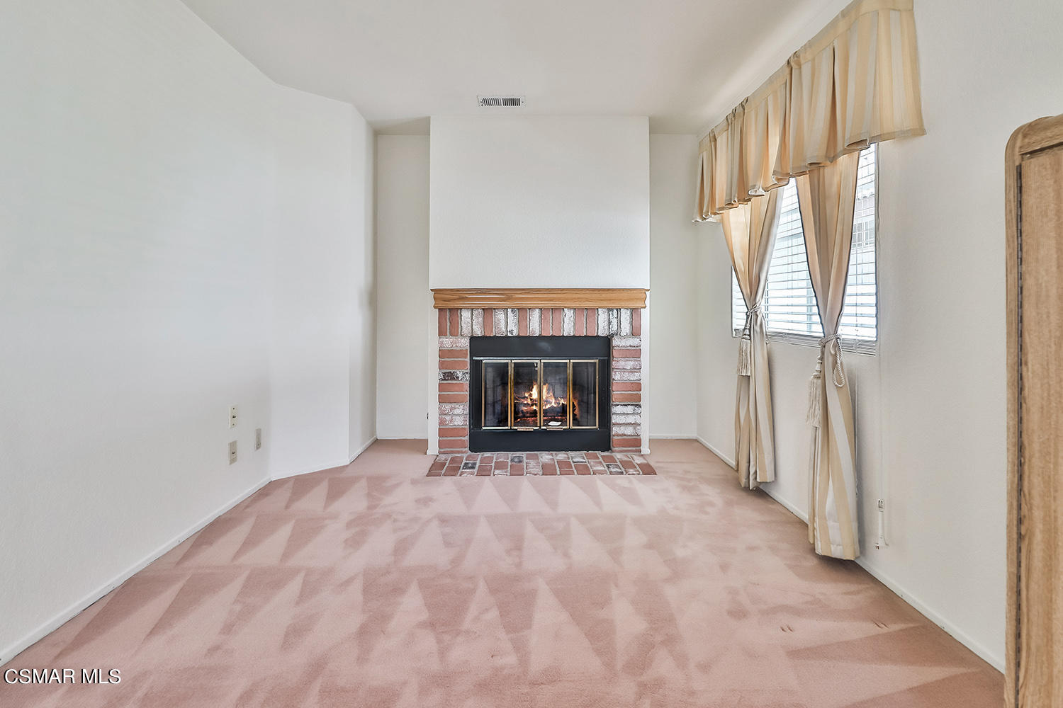 90 Valley Crest Road Simi Valley, CA 93065 - Photo 9 of 19 a view of an empty room with a fireplace and a window