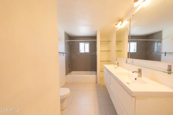 a large bathroom with a bathtub and a sink