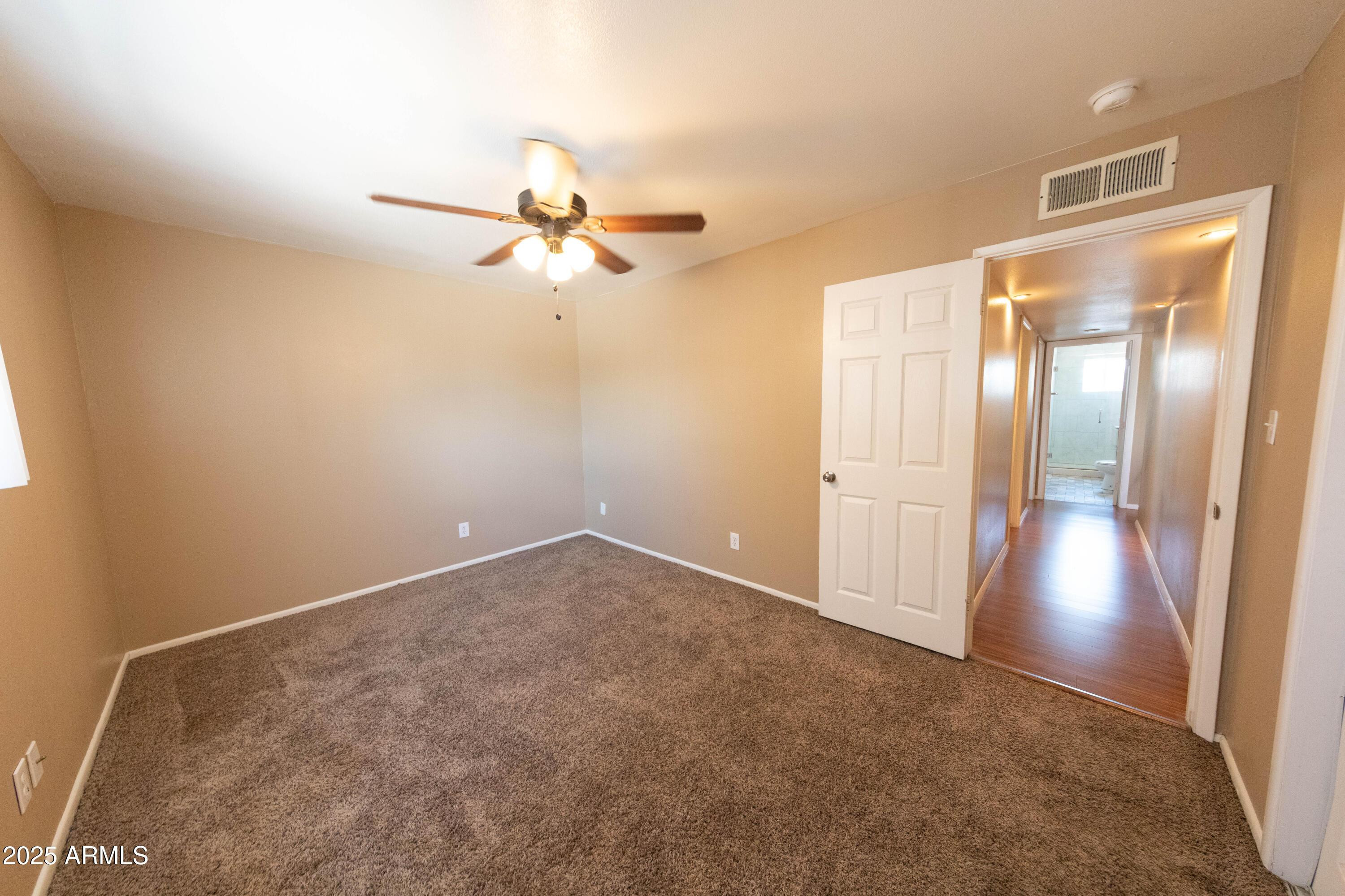 1149 West 10th Street Tempe, AZ 85281 - Photo 13 of 19 an empty room with closet and a chandelier fan