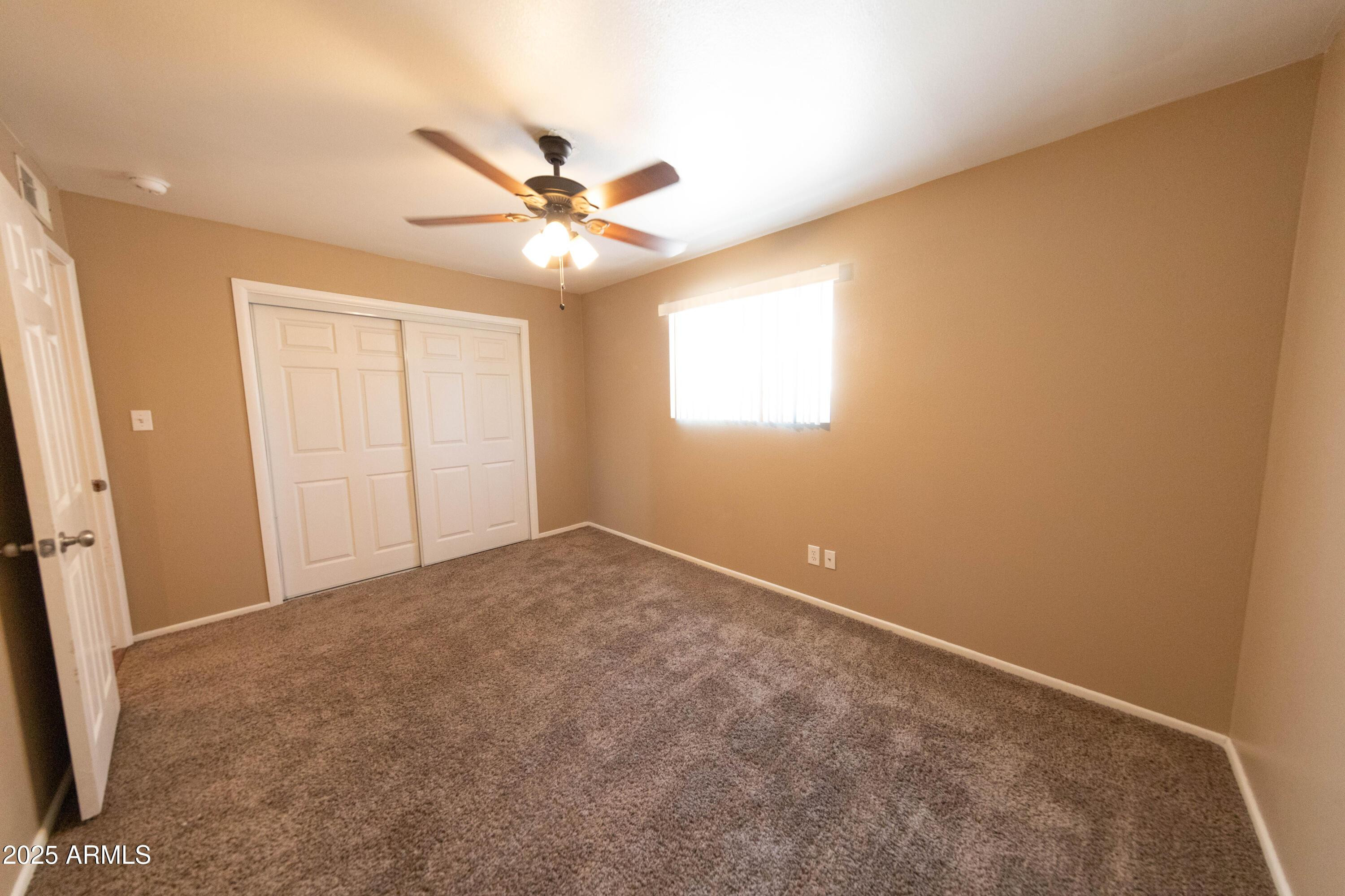 1149 West 10th Street Tempe, AZ 85281 - Photo 14 of 19 an empty room with windows and fan
